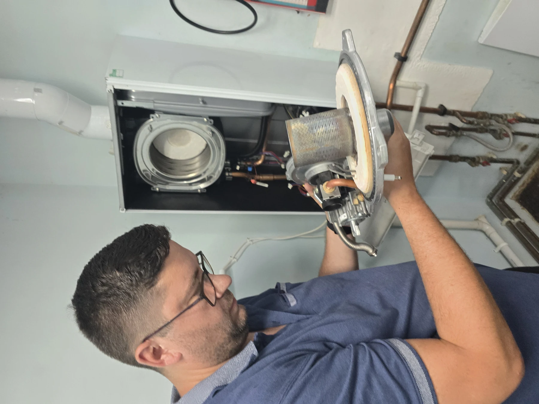 Engineer carefully inspecting a boiler during an annual service