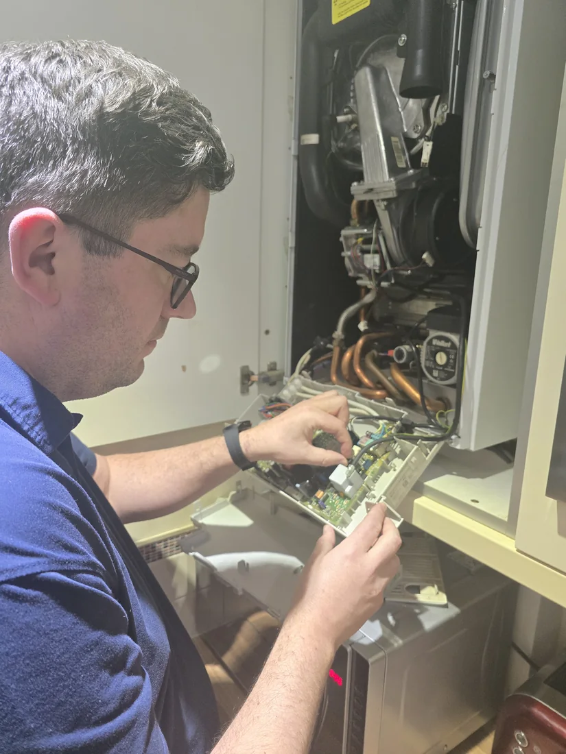 Engineer working inside a boiler